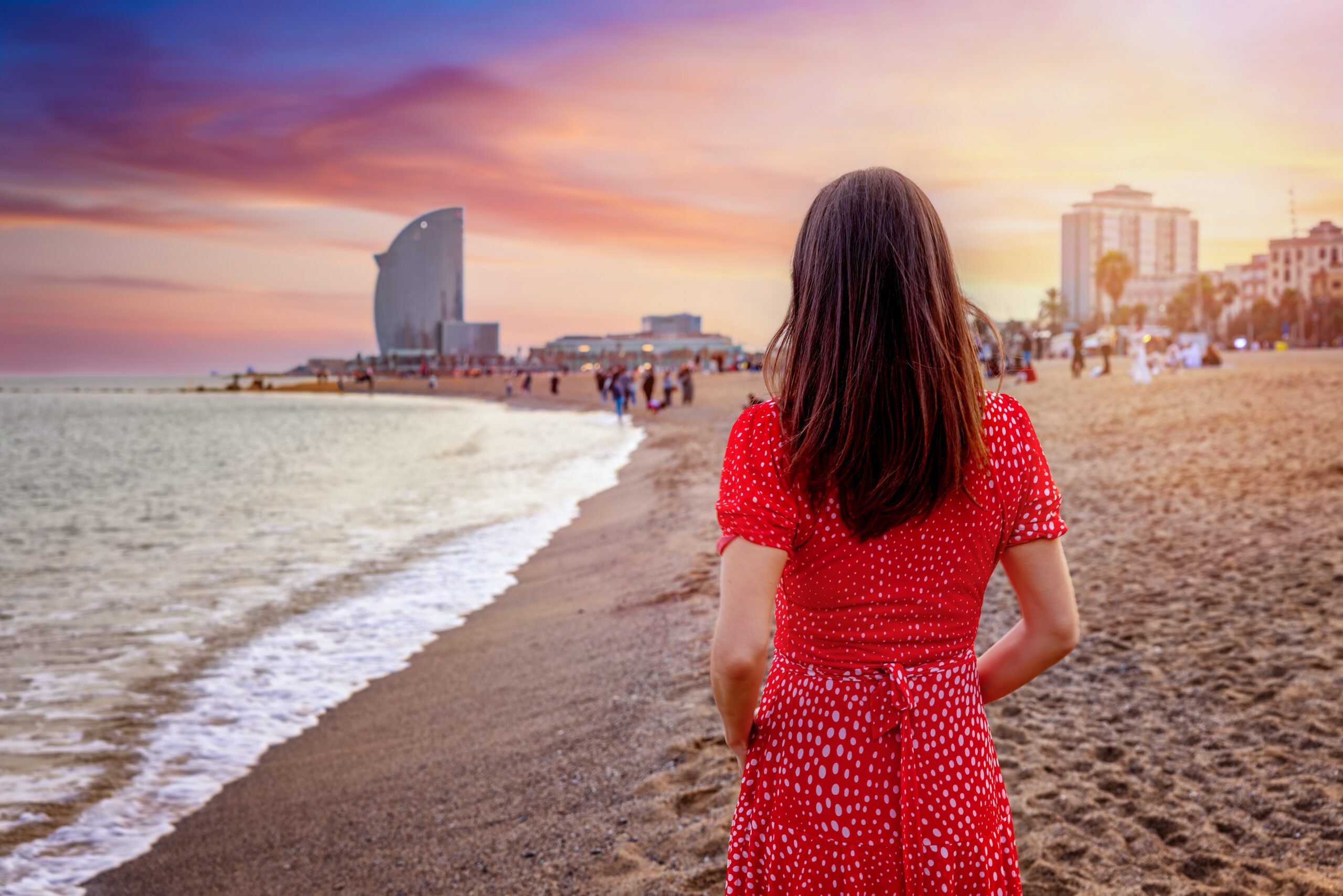 A,Tourist,Woman,Enjoys,The,Beautiful,Sunset,At,The,Barceloneta